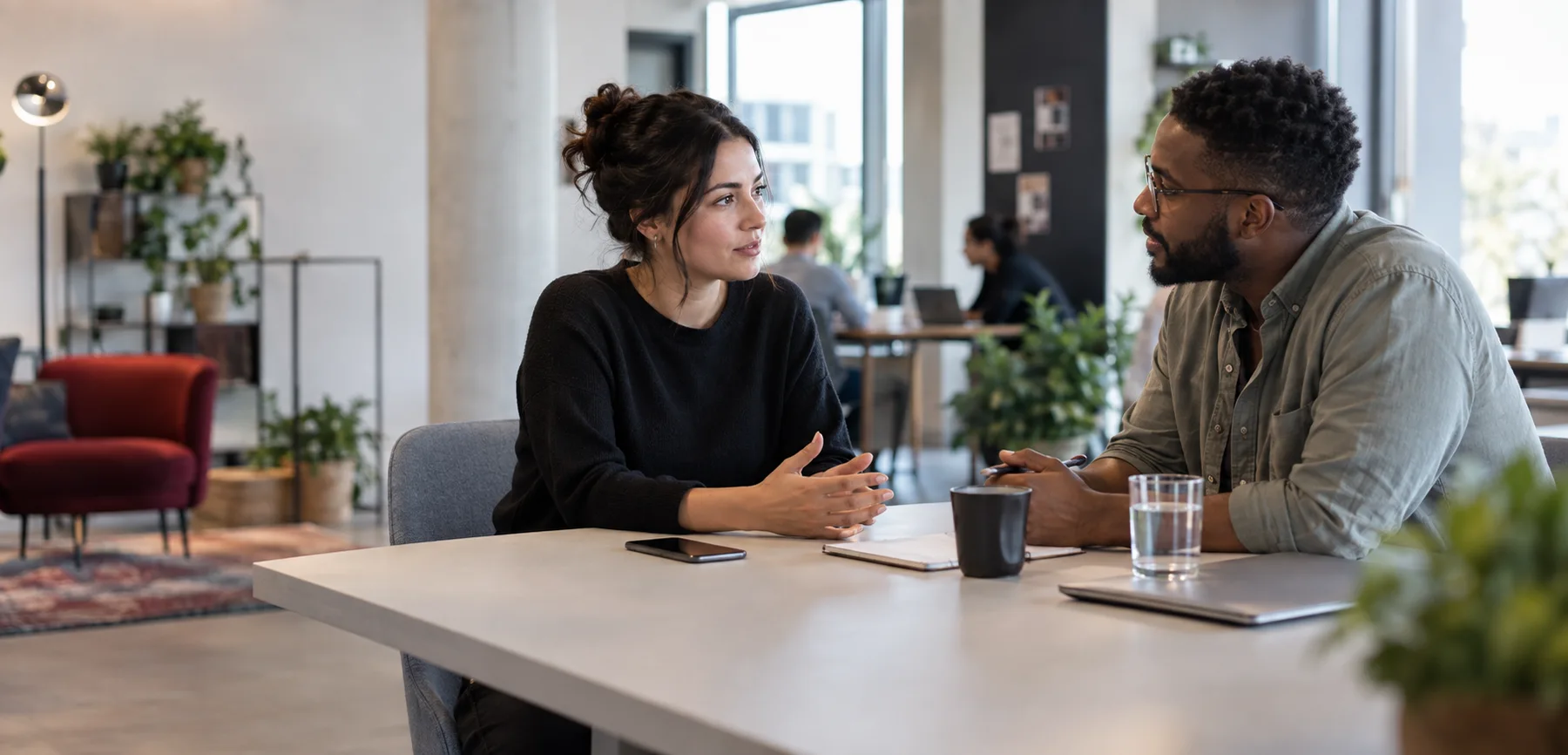 A candidate and recruiter in conversation in a shared workplace